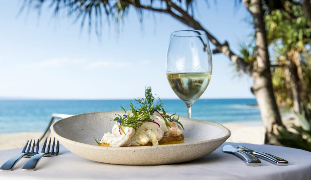 Meal and wine looking over Noosa Beach